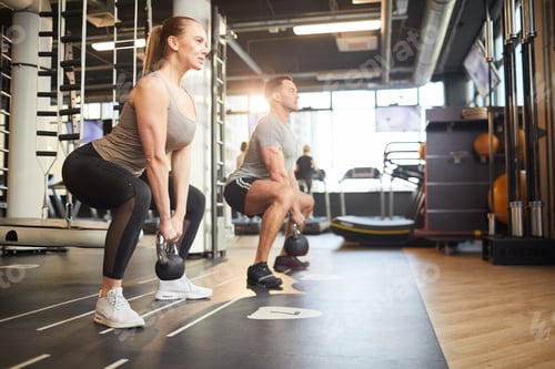Preview: Couple Doing Squats with Weights