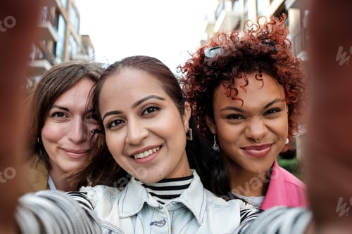 Preview: Three young women taking a selfie on city street