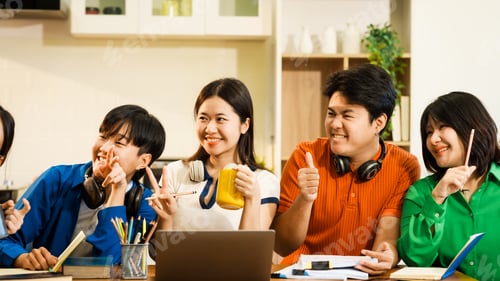 Preview: A group of young Asian college friends sitting on sofa at home,watching laptop,enjoying cheerful