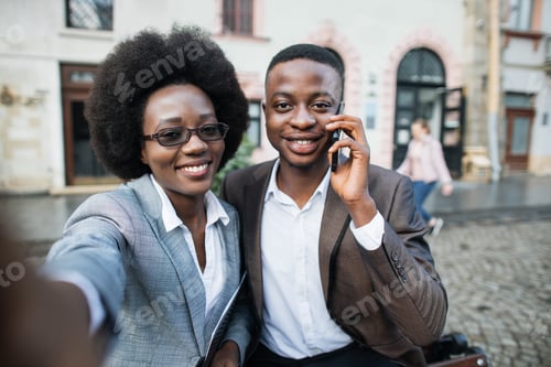 Preview: Cheerful business lady taking selfie on smartphone