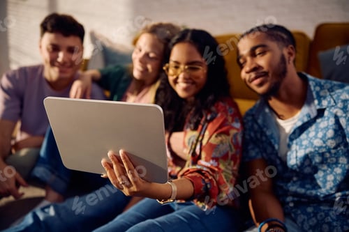 Preview: Close up of friends using digital tablet while taking selfie.