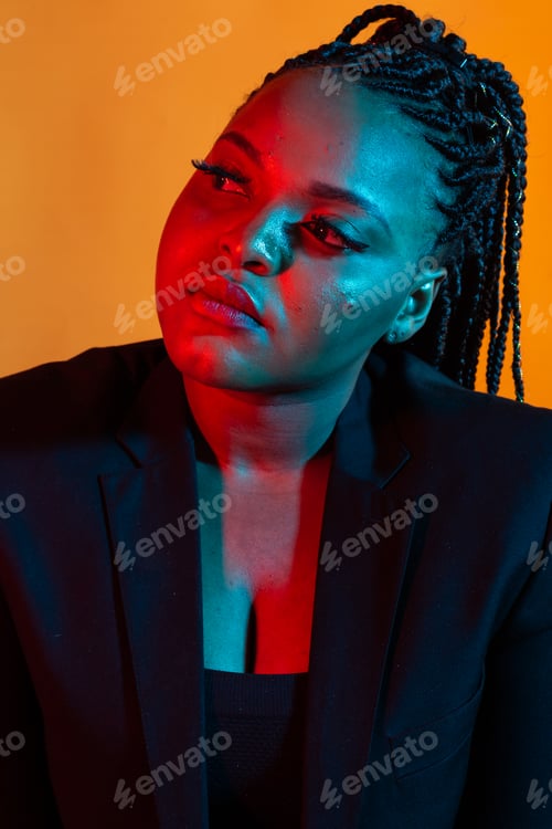 Preview: Portrait of beautiful african american female model posing. Colourful light