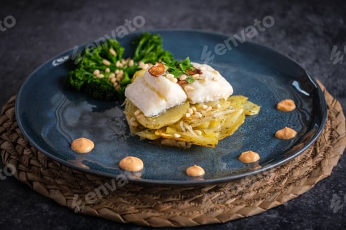 Preview: Appetizing gratin with fish served with sauce and broccoli