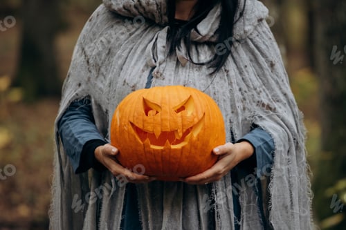 Preview: Horror background of a ghostly figure in enchanted a forest on a moody autumn day.