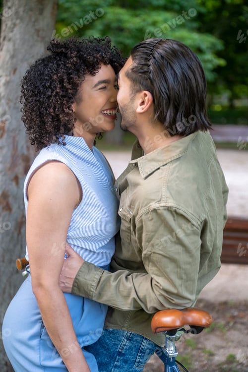Preview: Interracial couple sharing an intimate moment in park