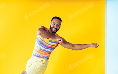 Preview: Man posing on colored backgrounds in studio wearing trendy clothes