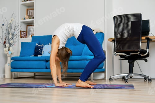 Preview: Young woman practicing yoga at home, doing inversion pose