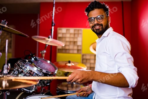 Preview: italian artist musician playing drumms during online concert at studio