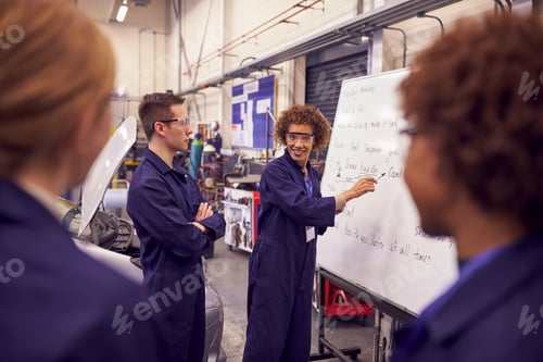 Preview: Female Tutor By Whiteboard With Students Teaching Auto Mechanic Apprenticeship At College