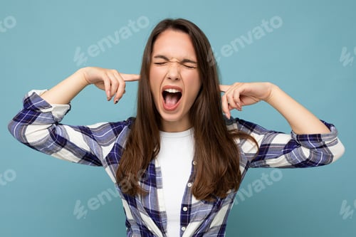 Preview: Don't want to hear it Young emotional attractive brunette female person isolated on blue background