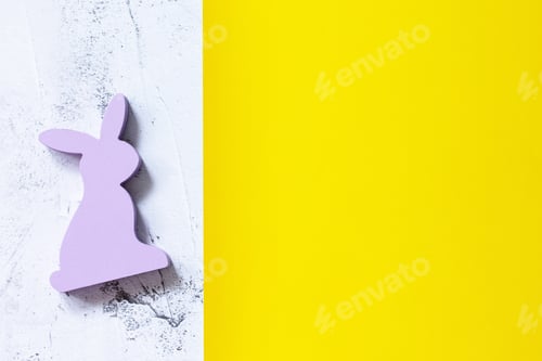 Preview: Minimal Easter concept. Bunny on yellow and gray background.