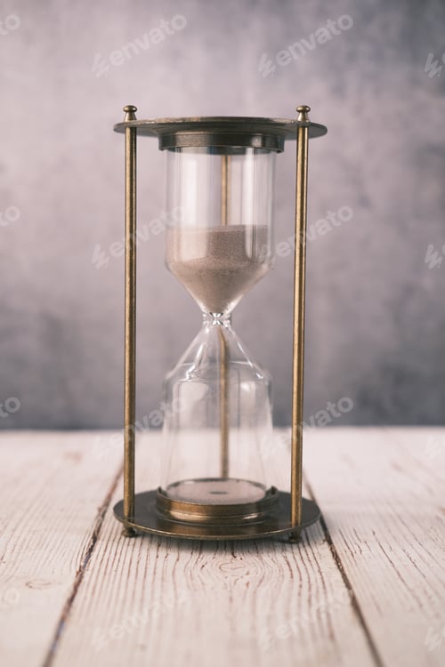 Preview: hourglass on table, sand flowing through the bulb of sandglass