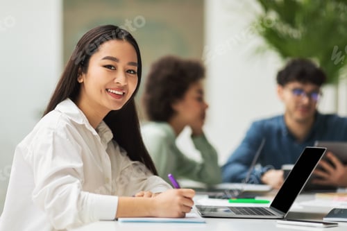 Preview: Asian Lady Using Laptop Sitting At Corporate Meeting In Office