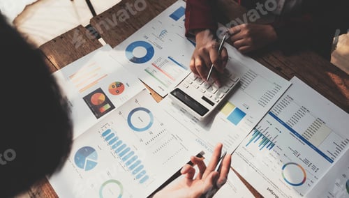 Preview: Business People Meeting using laptop computer,calculator,notebook,stock market chart paper for