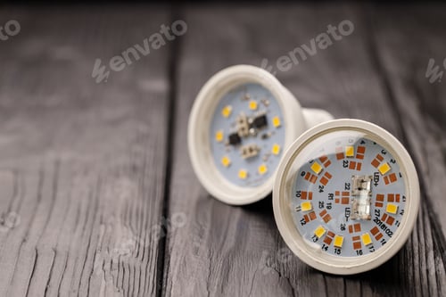 Preview: Light bulbs on dark wooden background close up