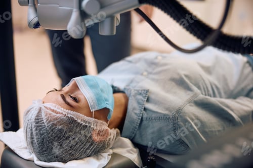 Preview: Young woman undergoing a laser eye surgery.