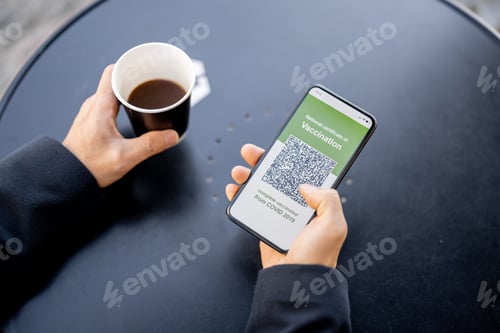 Preview: Man hold phone with app of Coronavirus Vaccination