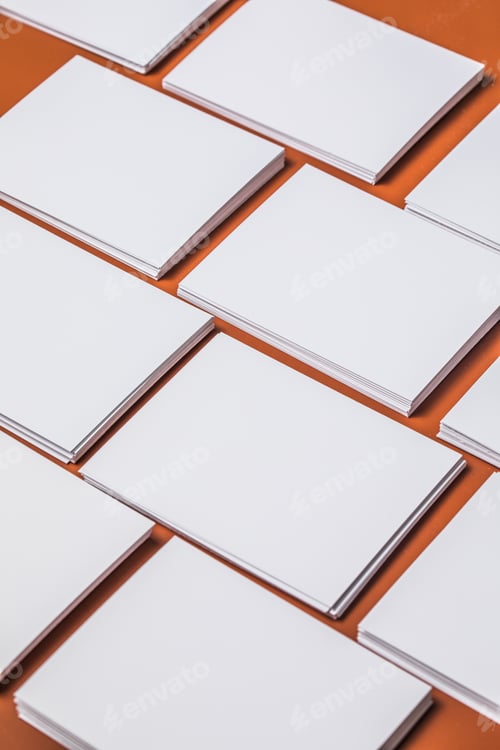 Preview: White sheet mockup. Stack of blank name cards. Blank white business card on brown paper background.
