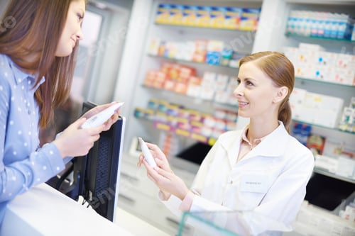 Preview: Female pharmacist advising with medicine
