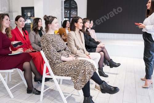 Preview: Side view of people listening to coach having speech at business training