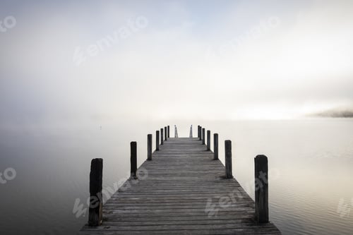 Preview: Grayscale shot of a wooden pier leading to the ocean