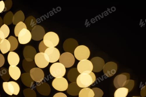 Preview: beautiful golden shiny defocused bokeh on black background