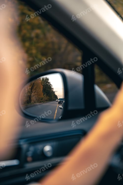 Preview: The view of the road in the car's rearview mirror.