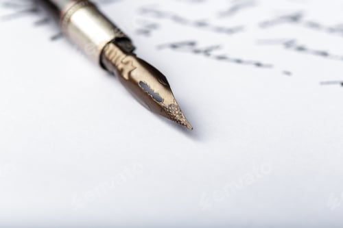 Preview: Writing a letter with a fountain pen on white paper in a quiet setting