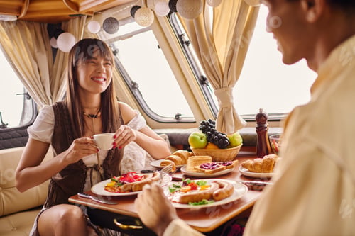 Preview: Smiling Couple Enjoying Breakfast Together Indoors