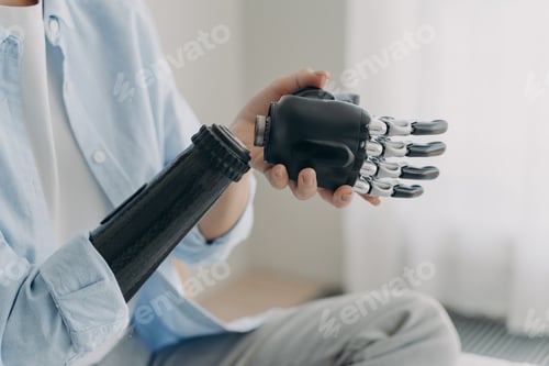 Preview: Artificial hand and arm with wrist joint. Disabled woman disassembling high technology prosthesis.