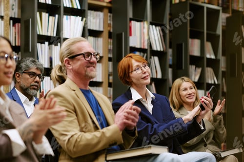 Preview: Diverse Group of Adults Attending Presentation in Library Setting