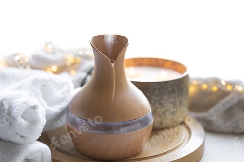 Preview: Cozy composition with essential oil aroma diffuser, towels and candles.
