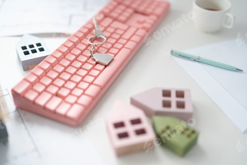 Preview: House keys on the colorful keyboard at the office table