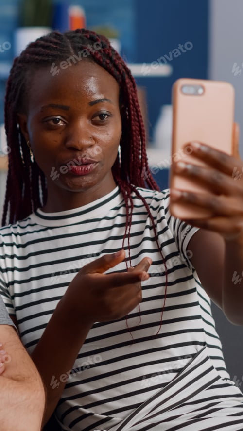 Preview: Young interracial couple using online video call conference