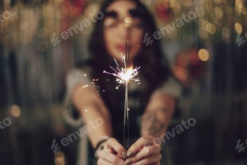 Preview: Young Woman Celebrating New Year's with Sparkler