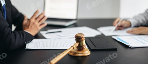Preview: Two people are sitting at a table with a gavel and papers in front of them