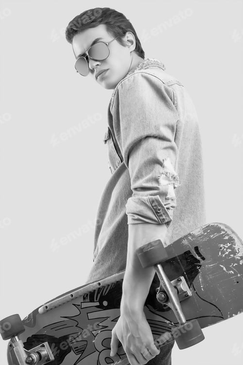 Preview: Portrait Of Handsome Hipster Man In Sunglasses Wearing Jeans Jacket Posing With Stylish Skateboard