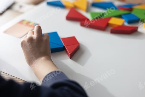 Preview: Child arranging colorful geometric shapes