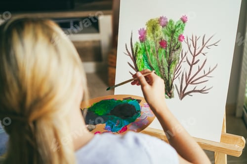 Preview: Female artist painting plants on canvas during spring time