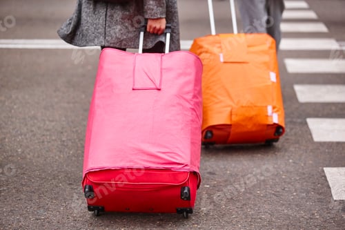 Preview: People croosing the street with baggage. Travel tourism background. Horizontal