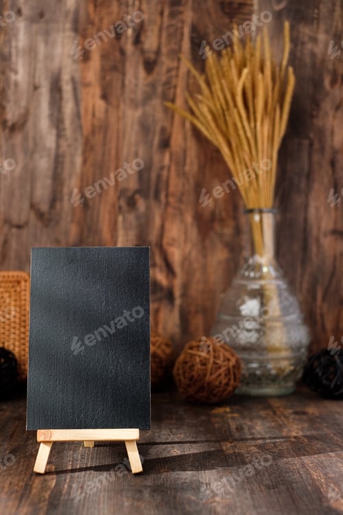 Preview: mockup blackbaord on wood table and decor with wicker countryside items.