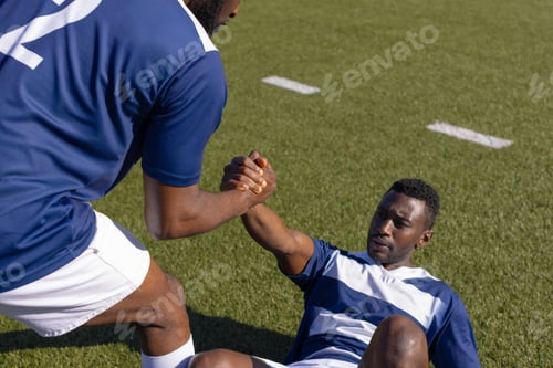Preview: Two African American young male athletes are training on field outdoors