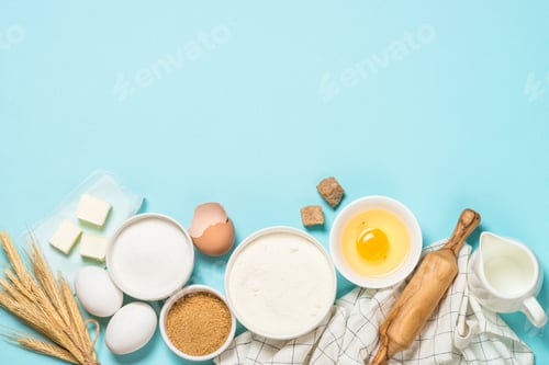 Preview: Baking ingredients at blue table top view