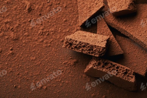 Preview: close up view of heap of chocolate bars in cocoa powder