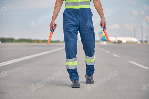 Preview: Signalman in workwear walking across the runway