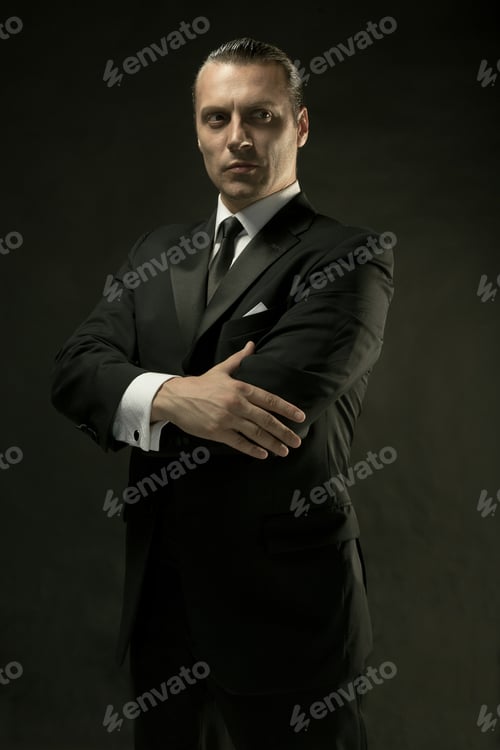 Preview: The Attractive Man In Black Suit On Dark Background