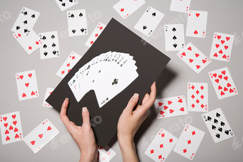 Preview: A woman holding a photograph of cards