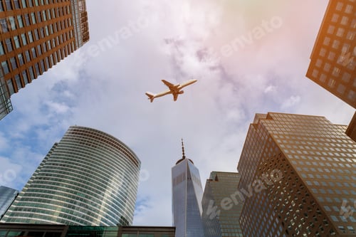Preview: Airplane flying over over city buildings in downtown skyscrapers over Manhattan, New York City.