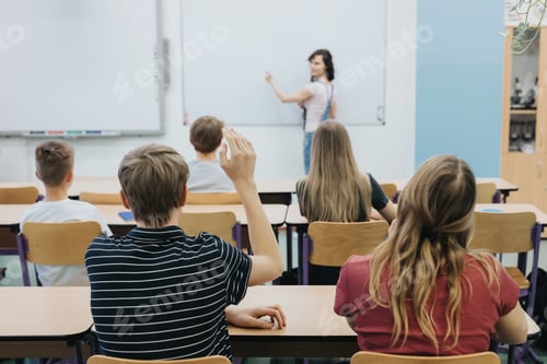 Preview: Teacher standing in front of the class room full of teenage students