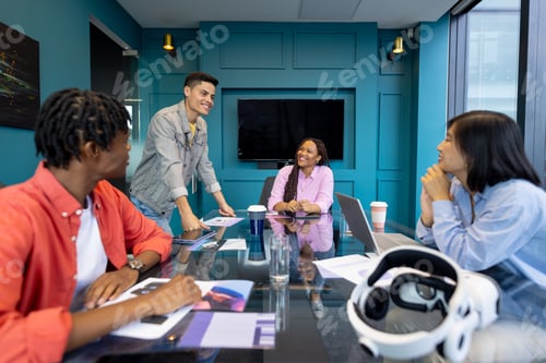 Preview: Diverse colleagues collaborate at a glass table on a startup project during their meeting